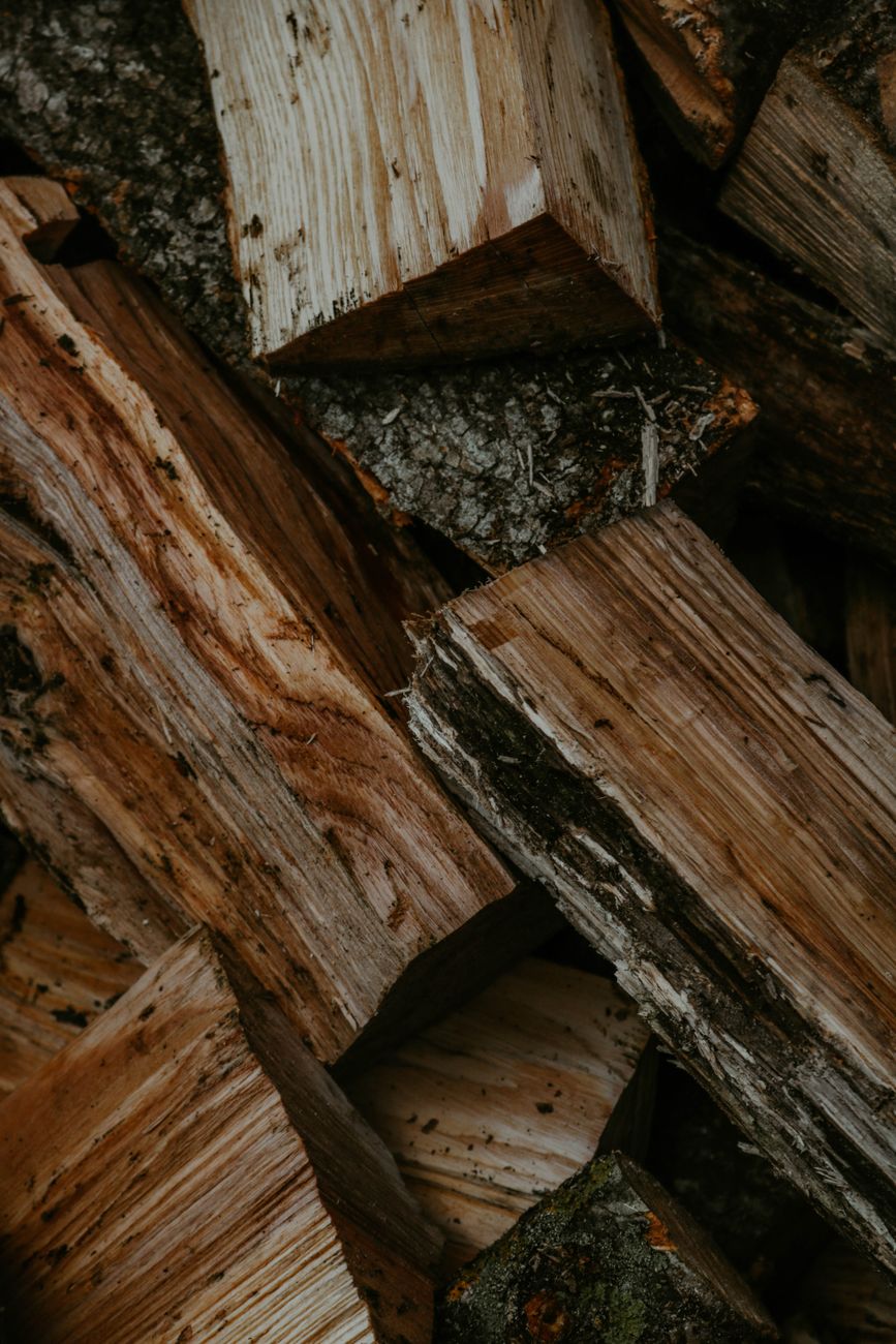 Detailed close-up of stacked firewood logs showcasing texture and natural patterns.