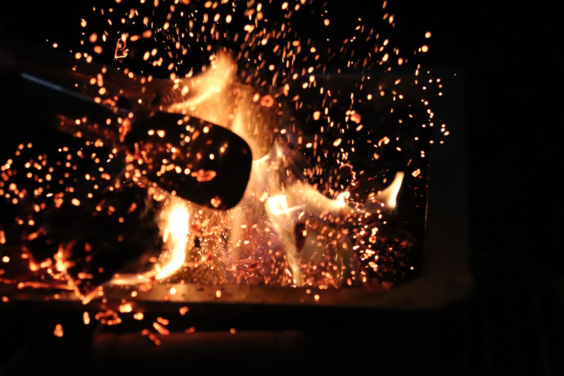 Captivating night scene of roaring fire with intense sparks.